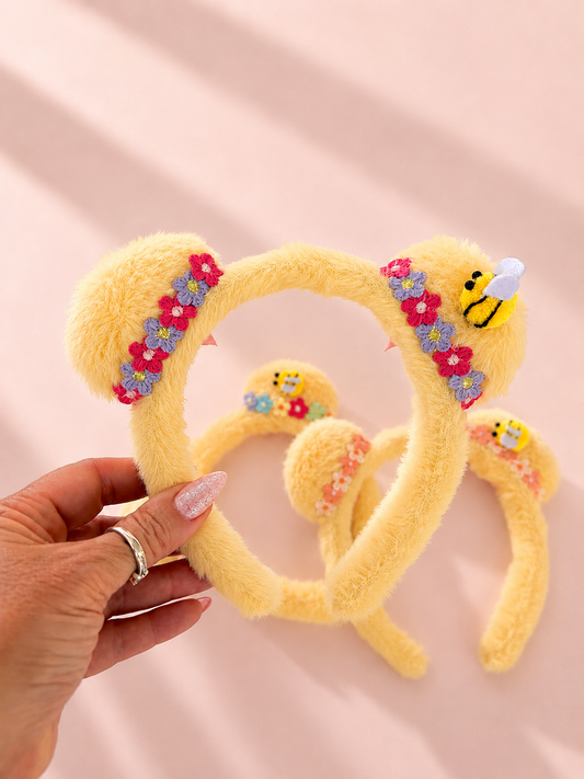 Pooh Ears close up embroidered flower and bee charm detail on plush mickey ears headband